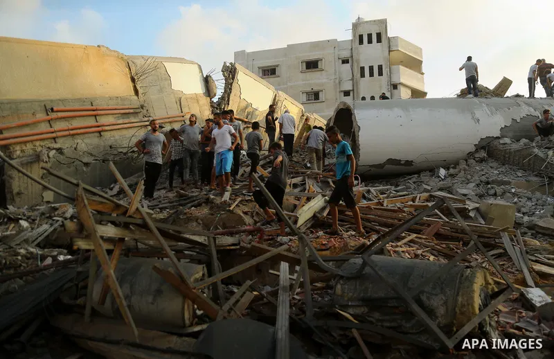 Palestinians inspect the rubble of a building following an Israeli air strike on Gaza City, on August 9, 2018. Photo by Dawoud Abo Alkas