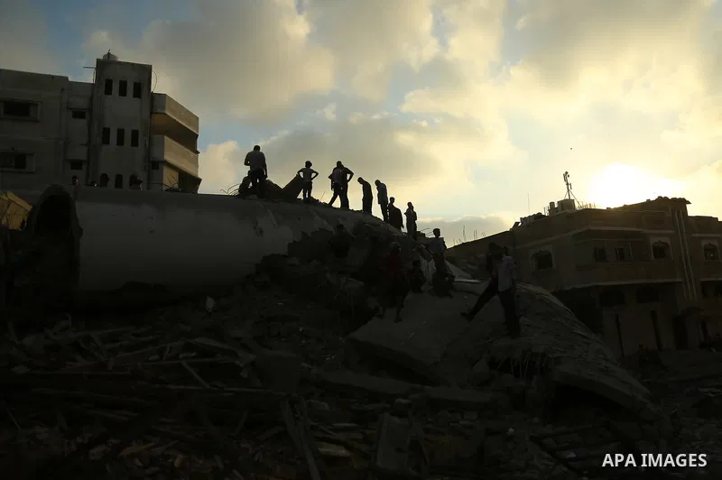 Palestinians inspect the rubble of a building following an Israeli air strike on Gaza City, on August 9, 2018. Photo by Dawoud Abo Alkas