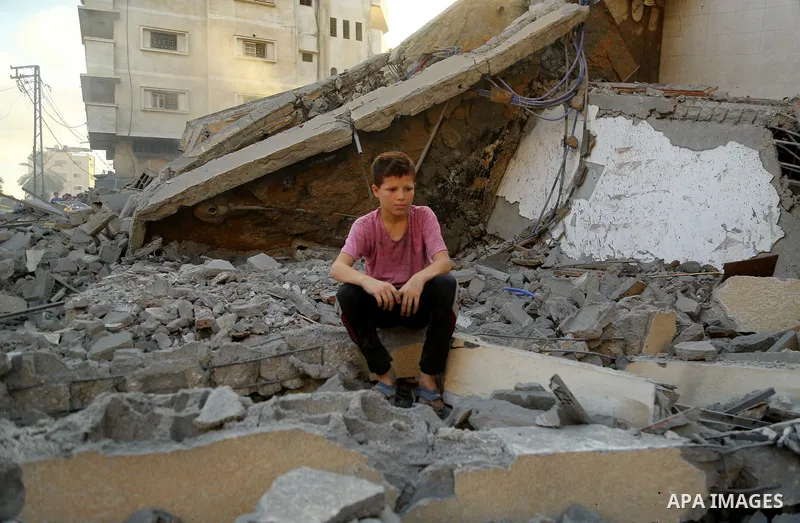 Palestinians inspect the rubble of a building following an Israeli air strike on Gaza City, on August 9, 2018. Photo by Dawoud Abo Alkas