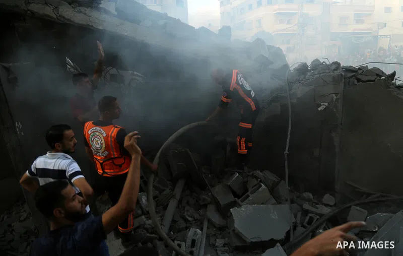 Palestinians inspect the rubble of a building following an Israeli air strike on Gaza City, on August 9, 2018. Photo by Dawoud Abo Alkas