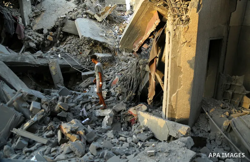 Palestinians inspect the rubble of a building following an Israeli air strike on Gaza City, on August 9, 2018. Photo by Dawoud Abo Alkas