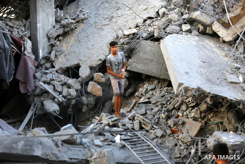 Palestinians inspect the rubble of a building following an Israeli air strike on Gaza City, on August 9, 2018. Photo by Dawoud Abo Alkas
