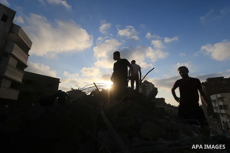 Palestinians inspect the rubble of a building following an Israeli air strike on Gaza City, on August 9, 2018. Photo by Mahmoud Khattab