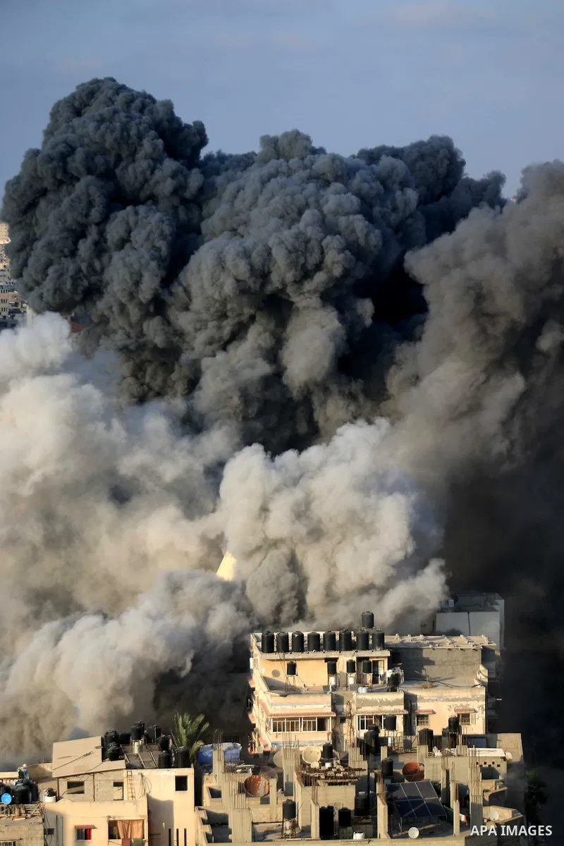 A picture taken on August 9, 2018 shows smoke plumes risisng following an Israeli air strike in Gaza City. Photo by Mahmoud Khattab