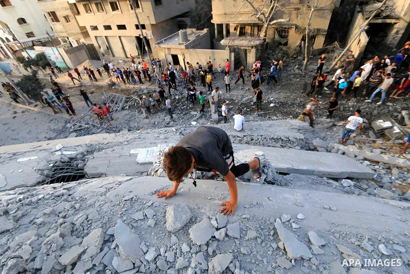 Palestinians inspect the rubble of a building following an Israeli air strike on Gaza City, on August 9, 2018. Photo by Mahmoud Khattab