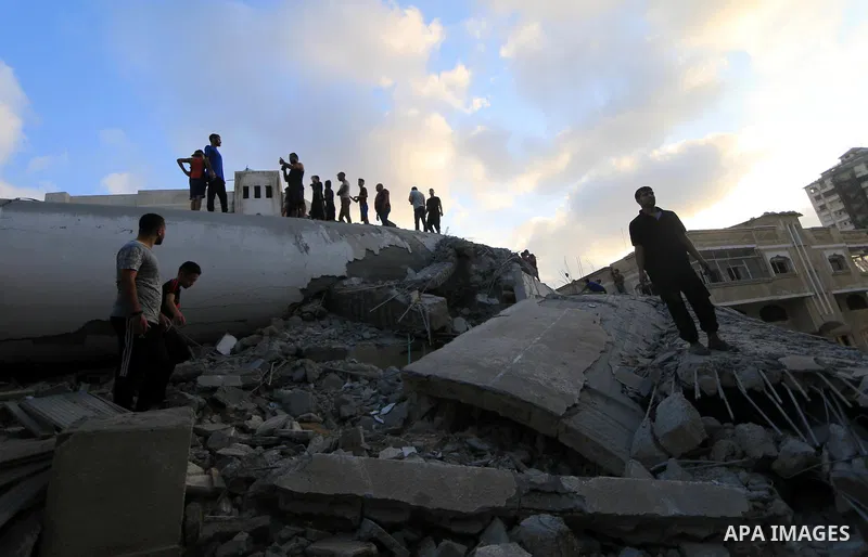 Palestinians inspect the rubble of a building following an Israeli air strike on Gaza City, on August 9, 2018. Photo by Mahmoud Khattab