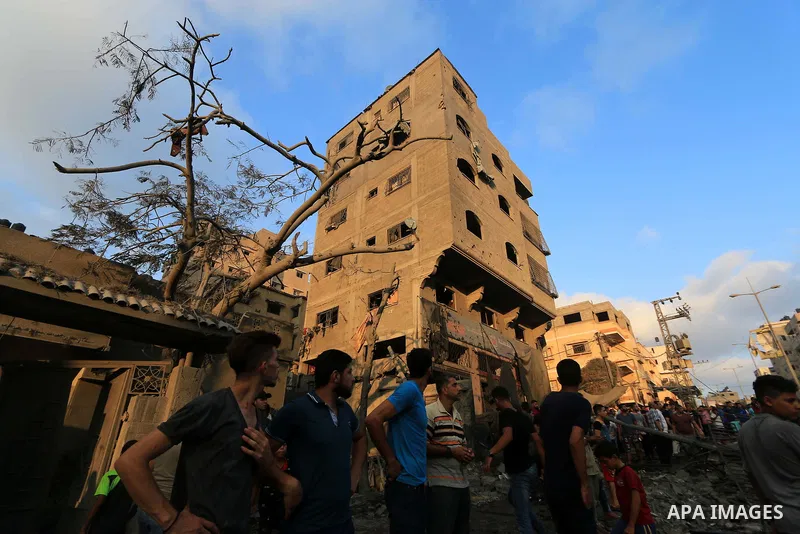 Palestinians inspect the rubble of a building following an Israeli air strike on Gaza City, on August 9, 2018. Photo by Mahmoud Khattab