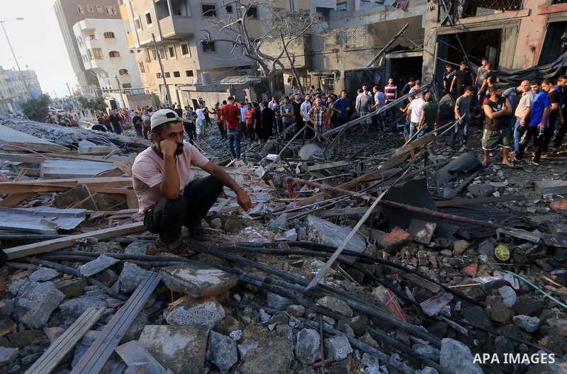 Palestinians inspect the rubble of a building following an Israeli air strike on Gaza City, on August 9, 2018. Photo by Mahmoud Khattab