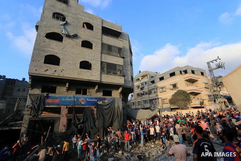 Palestinians inspect the rubble of a building following an Israeli air strike on Gaza City, on August 9, 2018. Photo by Mahmoud Khattab