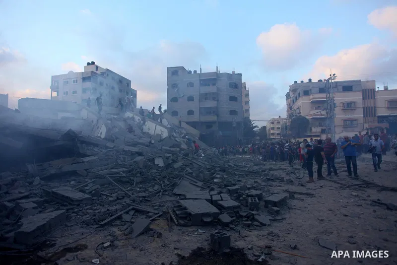 Palestinians inspect the rubble of a building following an Israeli air strike on Gaza City, on August 9, 2018. Photo by Mahmoud Ajour