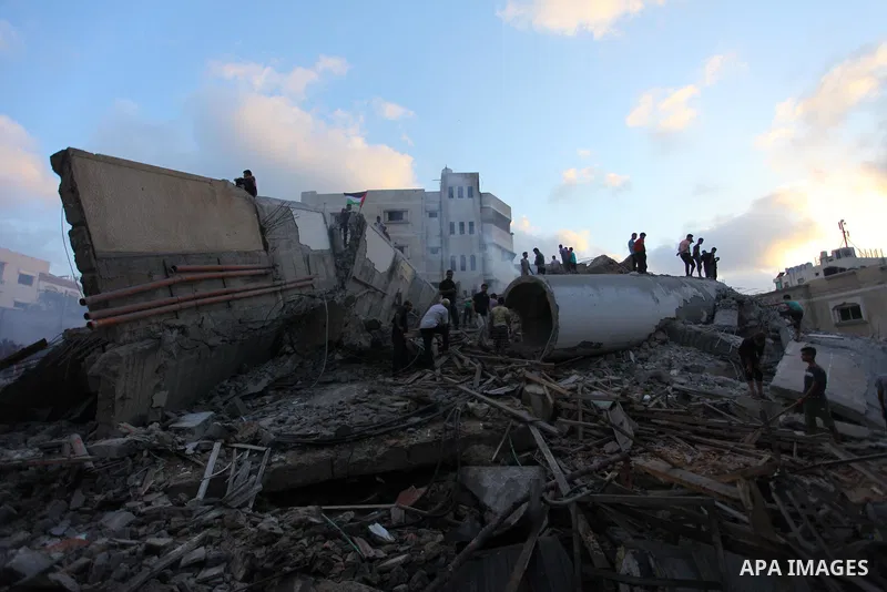 Palestinians inspect the rubble of a building following an Israeli air strike on Gaza City, on August 9, 2018. Photo by Mahmoud Ajour