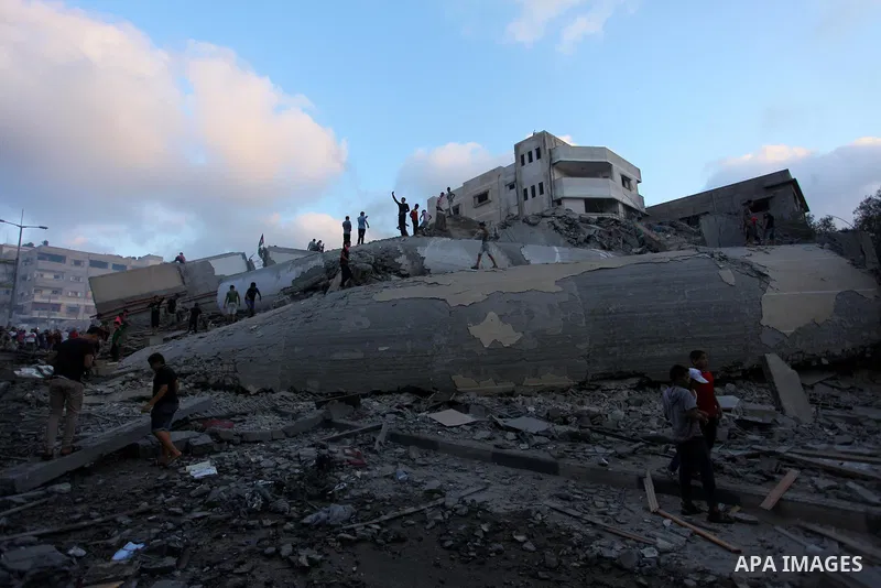 Palestinians inspect the rubble of a building following an Israeli air strike on Gaza City, on August 9, 2018. Photo by Mahmoud Ajour