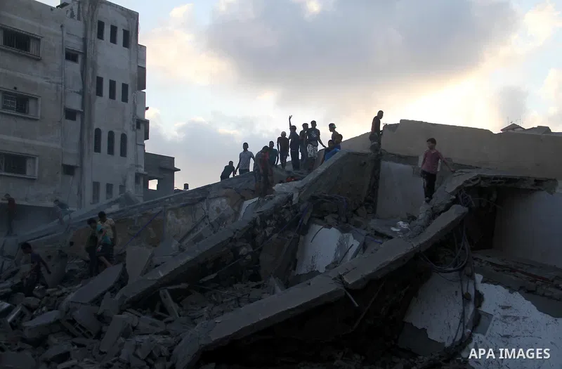 Palestinians inspect the rubble of a building following an Israeli air strike on Gaza City, on August 9, 2018. Photo by Mahmoud Ajour