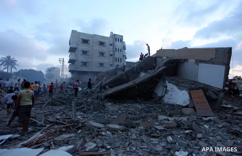 Palestinians inspect the rubble of a building following an Israeli air strike on Gaza City, on August 9, 2018. Photo by Mahmoud Ajour