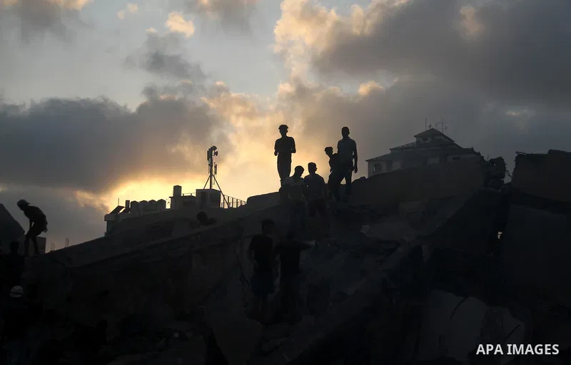 Palestinians inspect the rubble of a building following an Israeli air strike on Gaza City, on August 9, 2018. Photo by Mahmoud Ajour