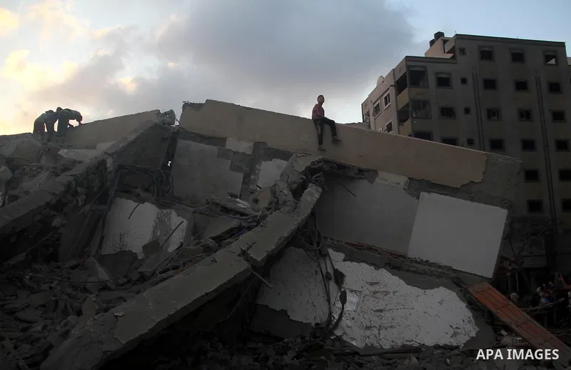 Palestinians inspect the rubble of a building following an Israeli air strike on Gaza City, on August 9, 2018. Photo by Mahmoud Ajour