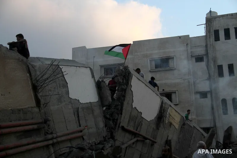 Palestinians inspect the rubble of a building following an Israeli air strike on Gaza City, on August 9, 2018. Photo by Mahmoud Ajour