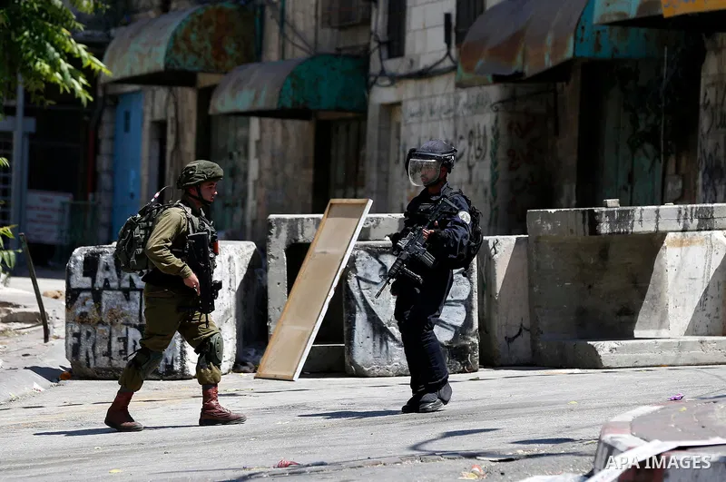 Israeli soldiers take position during clashes with Palestinian protesters in the West Bank city of Hebron on Aug. 10, 2018. Photo by Wisam Hashlamoun