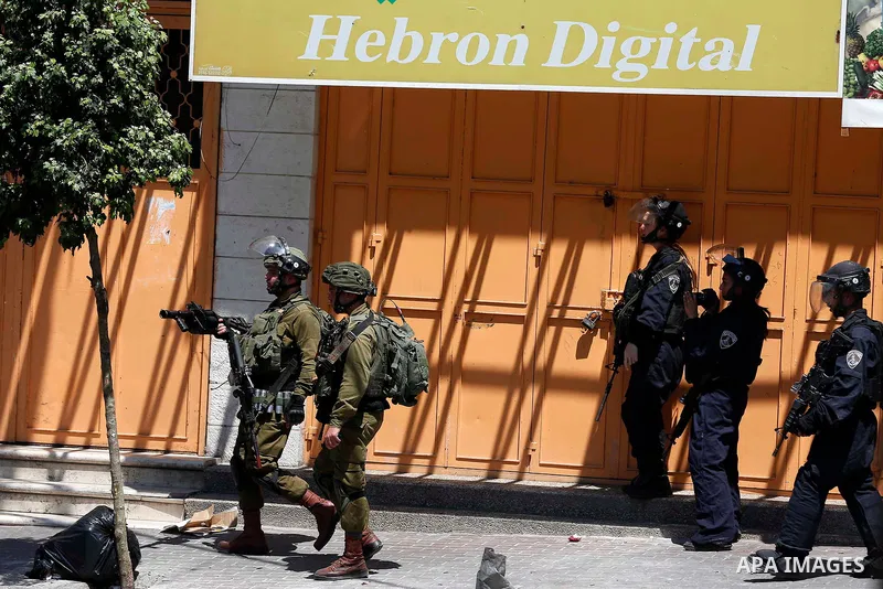 Israeli soldiers take position during clashes with Palestinian protesters in the West Bank city of Hebron on Aug. 10, 2018. Photo by Wisam Hashlamoun