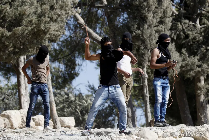 Palestinian protesters hurl stones towards Israeli troops during clashes in the West Bank city of Bethlehem on Aug. 10, 2018. Photo by Wisam Hashlamoun