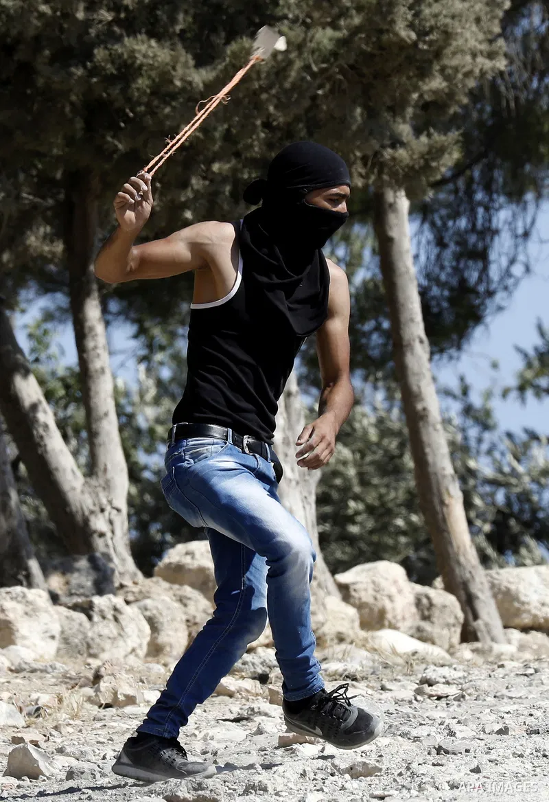 Palestinian protesters hurl stones towards Israeli troops during clashes in the West Bank city of Bethlehem on Aug. 10, 2018. Photo by Wisam Hashlamoun