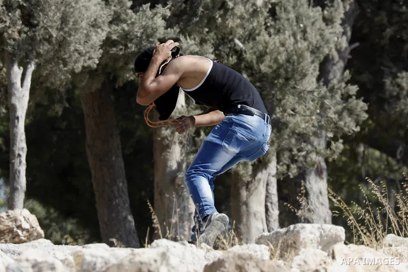 Palestinian protesters hurl stones towards Israeli troops during clashes in the West Bank city of Bethlehem on Aug. 10, 2018. Photo by Wisam Hashlamoun