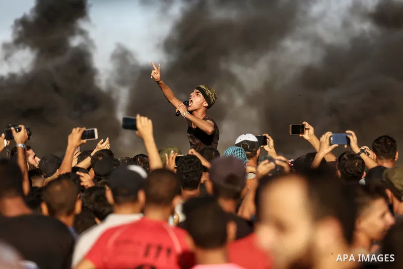 Palestinian protesters gather during clashes with Israeli troops in tents protest where Palestinian demand the right to return to their homeland at the Israel-Gaza border, in east of Gaza City on Aug. 10, 2018. Photo by...