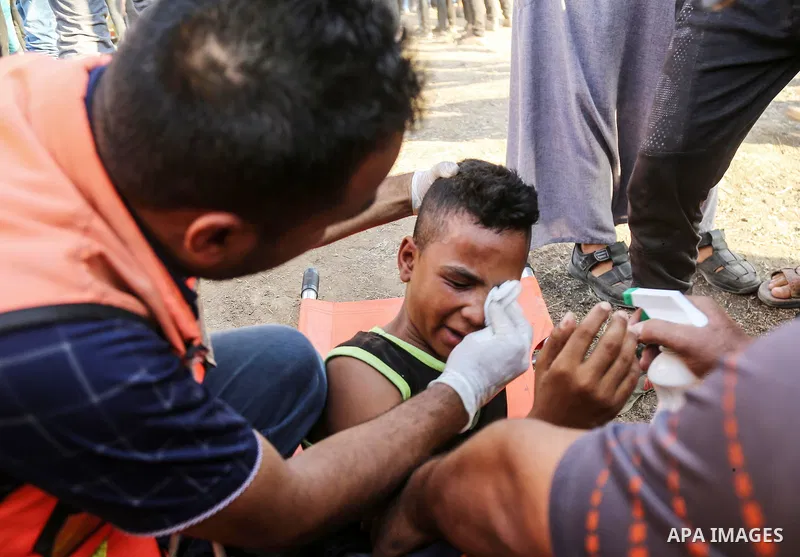 A wounded Palestinian protester receives treatment during clashes with Israeli troops in tents protest where Palestinian demand the right to return to their homeland at the Israel-Gaza border, in east of Gaza City on Aug...