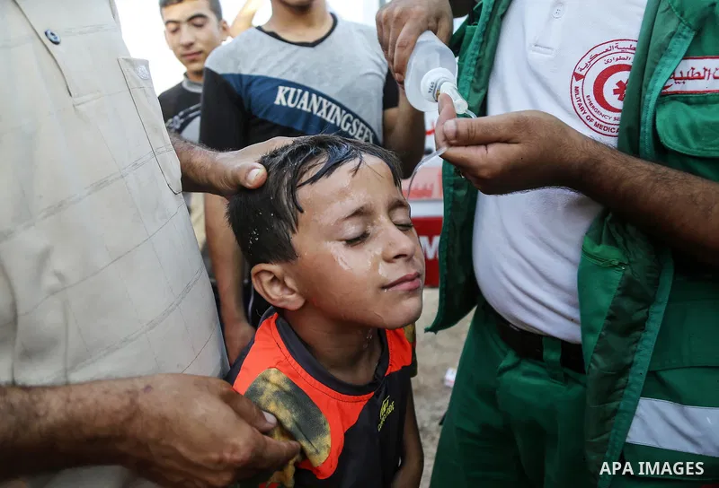 A wounded Palestinian protester receives treatment during clashes with Israeli troops in tents protest where Palestinian demand the right to return to their homeland at the Israel-Gaza border, in east of Gaza City on Aug...