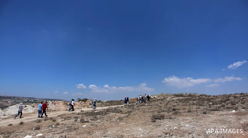 Palestinian youths participate in a tour at Asira al-Shamaliya village near the West Bank city of Nablus on Aug. 10, 2018. Photo by Shadi Jarar'ah