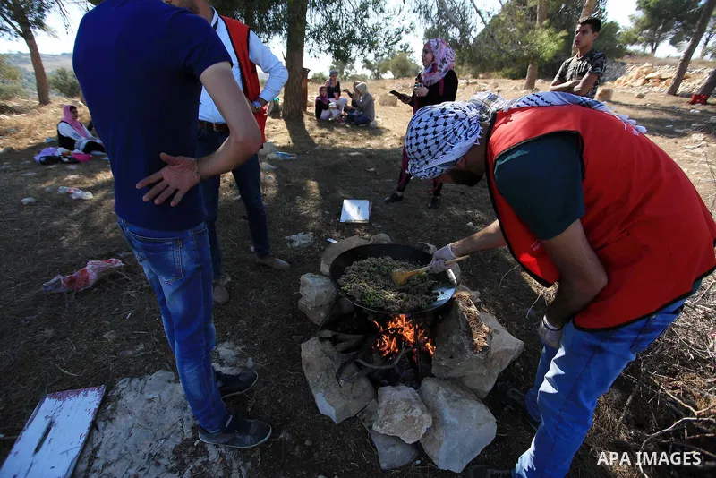 Palestinian youths participate in a tour at Asira al-Shamaliya village near the West Bank city of Nablus on Aug. 10, 2018. Photo by Shadi Jarar'ah
