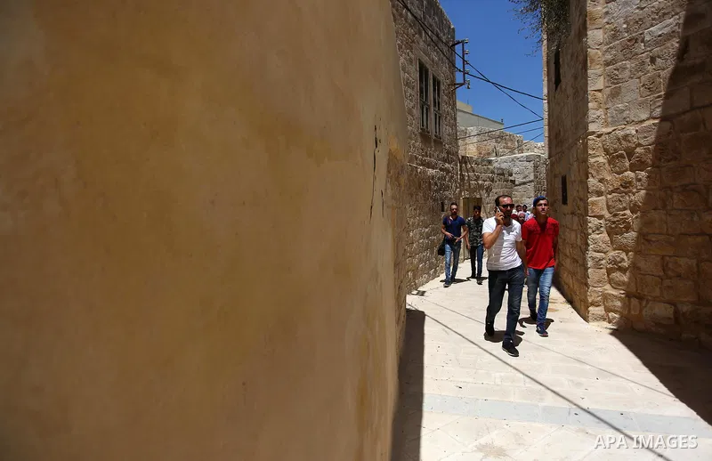 Palestinian youths participate in a tour at Asira al-Shamaliya village near the West Bank city of Nablus on Aug. 10, 2018. Photo by Shadi Jarar'ah