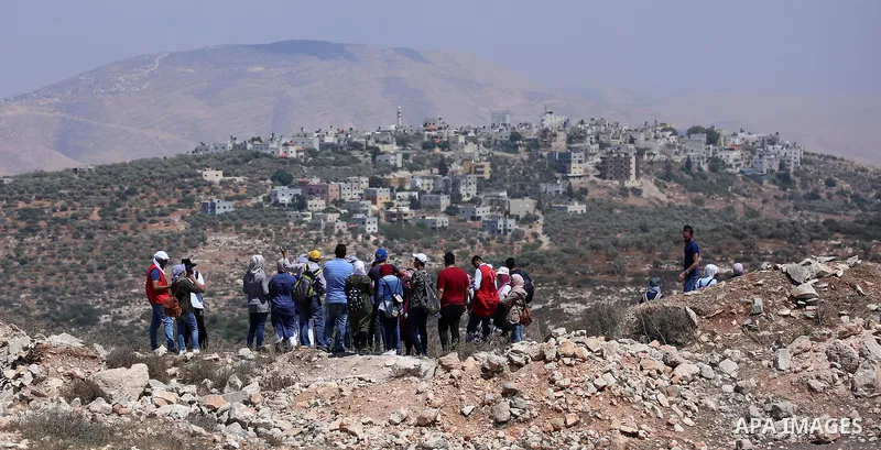 Palestinian youths participate in a tour at Asira al-Shamaliya village near the West Bank city of Nablus on Aug. 10, 2018. Photo by Shadi Jarar'ah