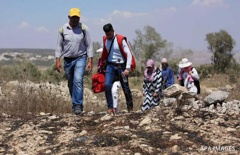 Palestinian youths participate in a tour at Asira al-Shamaliya village near the West Bank city of Nablus on Aug. 10, 2018. Photo by Shadi Jarar'ah