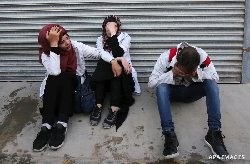 Colleagues of Palestinian medic Abdullah Al-Kotati, who was killed by Israeli troops while trying to help wounded protesters during clashes where Palestinians demand the right to return to their homeland at the Israel-Ga...