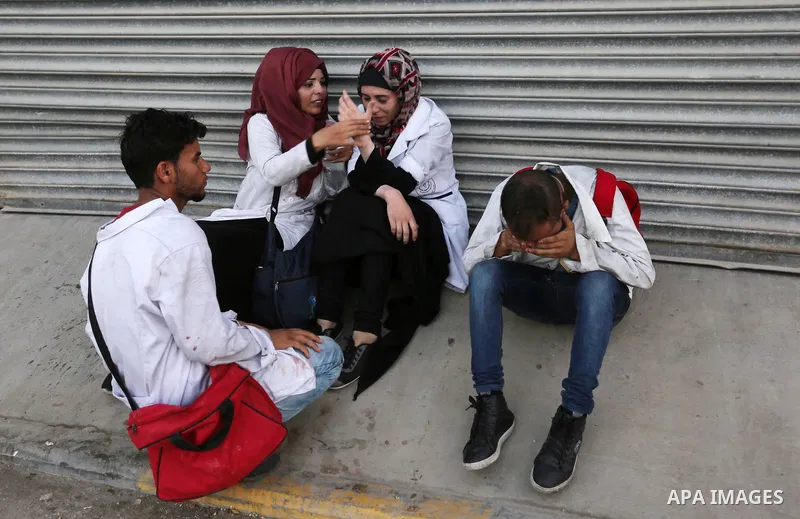 Colleagues of Palestinian medic Abdullah Al-Kotati, who was killed by Israeli troops while trying to help wounded protesters during clashes where Palestinians demand the right to return to their homeland at the Israel-Ga...