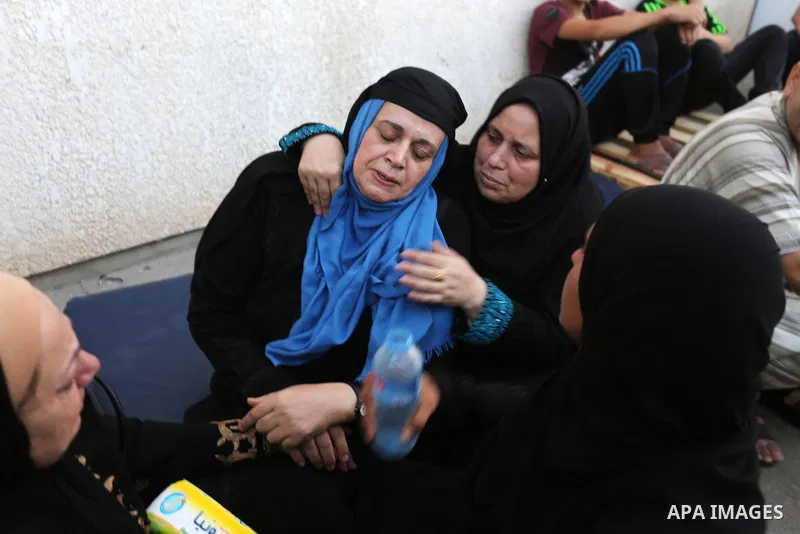 Relatives of Palestinian medic Abdullah Al-Kotati, who was killed by Israeli troops while trying to help wounded protesters during clashes where Palestinians demand the right to return to their homeland at the Israel-Gaz...