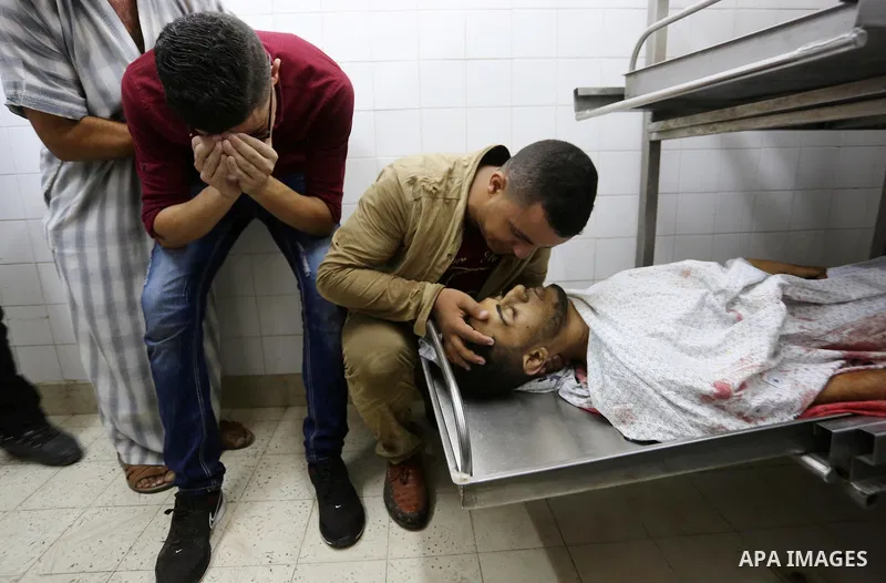 Relatives of Palestinian medic Abdullah Al-Kotati, who was killed by Israeli troops while trying to help wounded protesters during clashes where Palestinians demand the right to return to their homeland at the Israel-Gaz...
