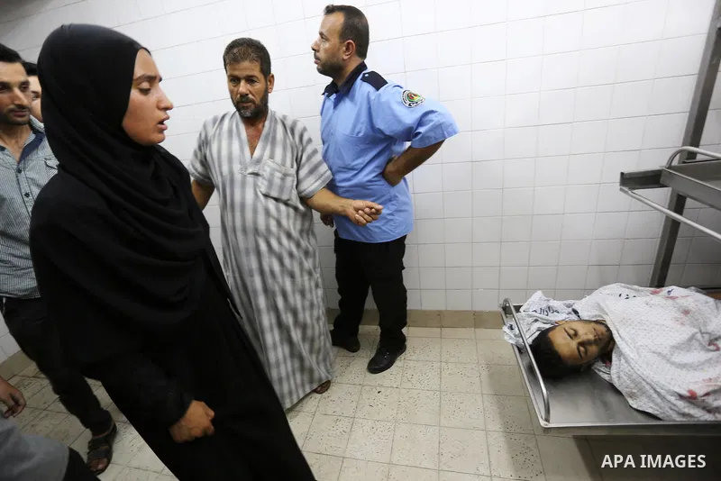 Relatives of Palestinian medic Abdullah Al-Kotati, who was killed by Israeli troops while trying to help wounded protesters during clashes where Palestinians demand the right to return to their homeland at the Israel-Gaz...