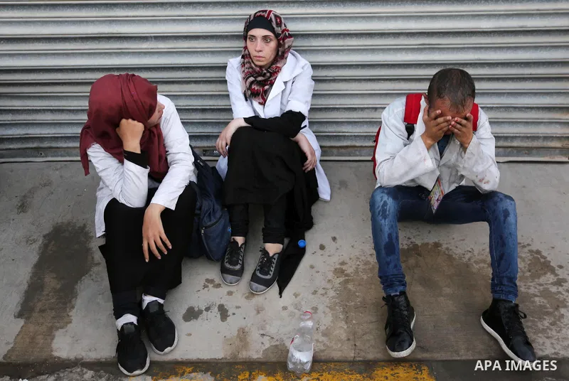 Colleagues of Palestinian medic Abdullah Al-Kotati, who was killed by Israeli troops while trying to help wounded protesters during clashes where Palestinians demand the right to return to their homeland at the Israel-Ga...