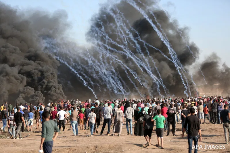 Palestinian protesters gather during clashes with Israeli troops in tents protest where Palestinian demand the right to return to their homeland at the Israel-Gaza border, in east of Gaza City on Aug. 10, 2018. Photo by...