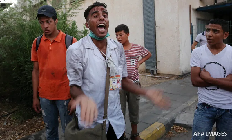Colleagues of Palestinian medic Abdullah Al-Kotati, who was killed by Israeli troops while trying to help wounded protesters during clashes where Palestinians demand the right to return to their homeland at the Israel-Ga...