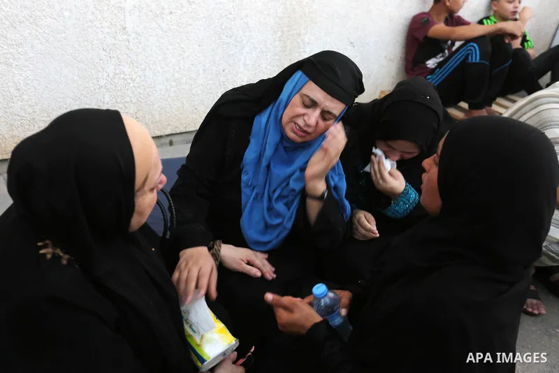 Relatives of Palestinian medic Abdullah Al-Kotati, who was killed by Israeli troops while trying to help wounded protesters during clashes where Palestinians demand the right to return to their homeland at the Israel-Gaz...