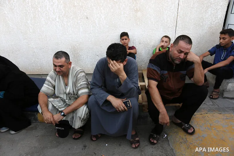 Relatives of Palestinian medic Abdullah Al-Kotati, who was killed by Israeli troops while trying to help wounded protesters during clashes where Palestinians demand the right to return to their homeland at the Israel-Gaz...