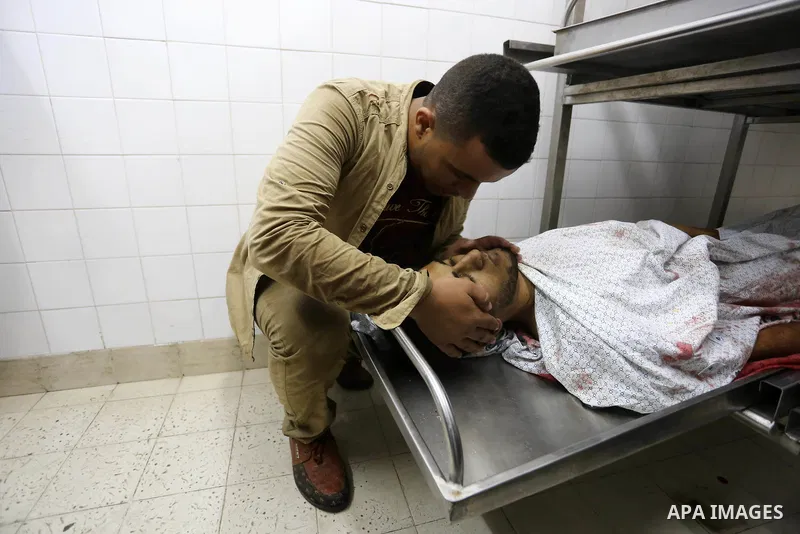 Relatives of Palestinian medic Abdullah Al-Kotati, who was killed by Israeli troops while trying to help wounded protesters during clashes where Palestinians demand the right to return to their homeland at the Israel-Gaz...
