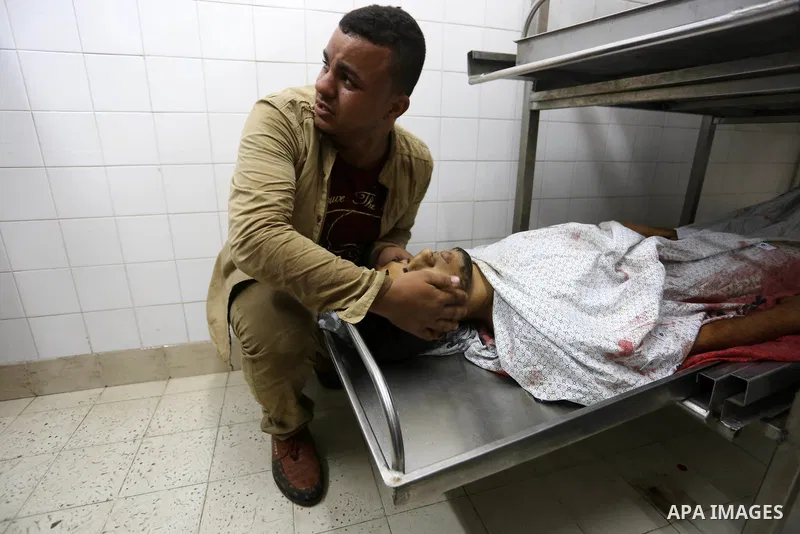 Relatives of Palestinian medic Abdullah Al-Kotati, who was killed by Israeli troops while trying to help wounded protesters during clashes where Palestinians demand the right to return to their homeland at the Israel-Gaz...