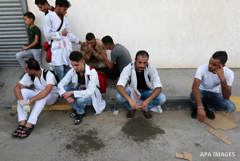 Colleagues of Palestinian medic Abdullah Al-Kotati, who was killed by Israeli troops while trying to help wounded protesters during clashes where Palestinians demand the right to return to their homeland at the Israel-Ga...