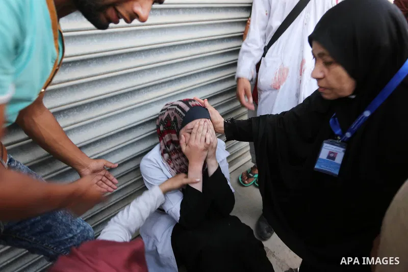 Colleagues of Palestinian medic Abdullah Al-Kotati, who was killed by Israeli troops while trying to help wounded protesters during clashes where Palestinians demand the right to return to their homeland at the Israel-Ga...