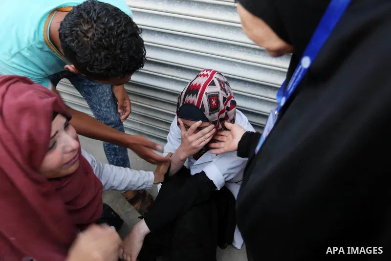 Colleagues of Palestinian medic Abdullah Al-Kotati, who was killed by Israeli troops while trying to help wounded protesters during clashes where Palestinians demand the right to return to their homeland at the Israel-Ga...