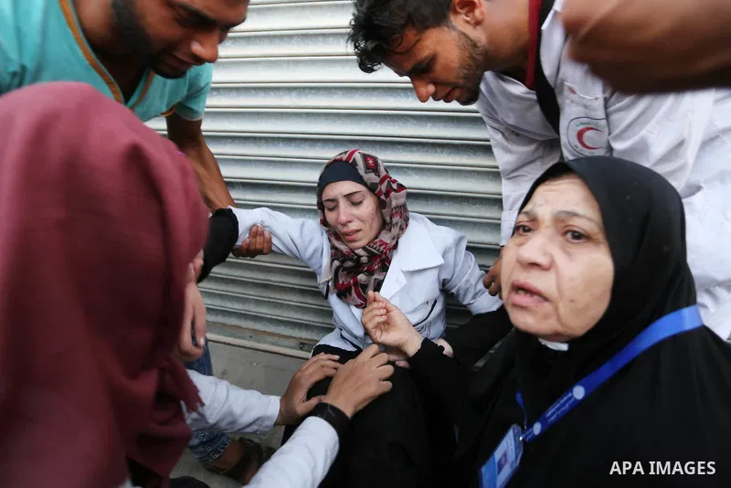 Colleagues of Palestinian medic Abdullah Al-Kotati, who was killed by Israeli troops while trying to help wounded protesters during clashes where Palestinians demand the right to return to their homeland at the Israel-Ga...